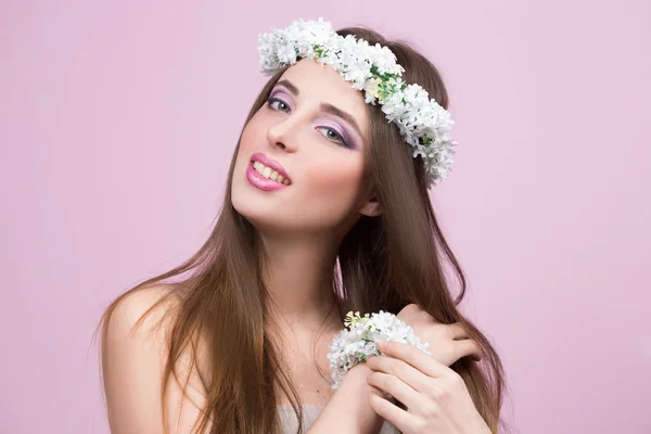 Young model with bright flowers on her head — Stock Photo, Image