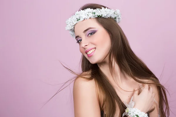 Jonge model met heldere bloemen op haar hoofd — Stockfoto
