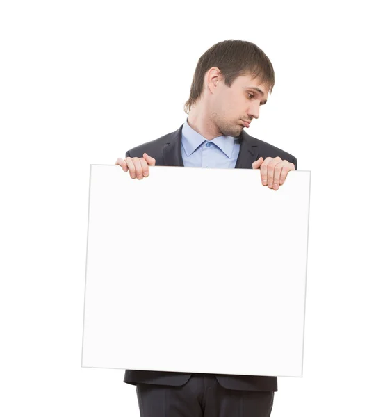 Sad businessman holding a white blank — Stock Photo, Image
