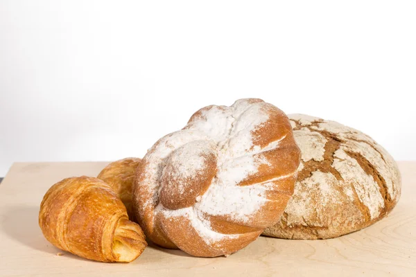 Baked bread on wood table — Stock Photo, Image