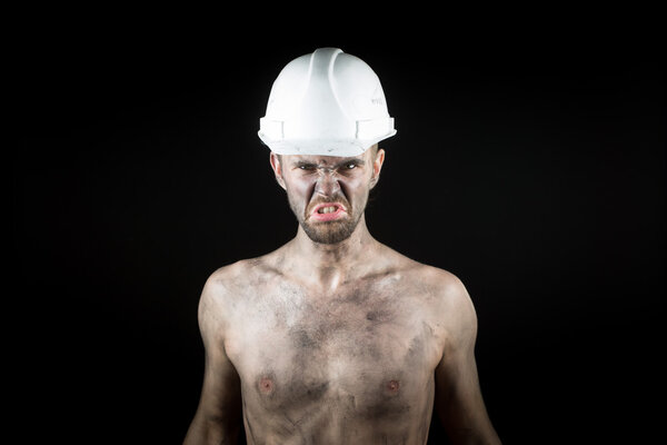 angry working in a dirty helmet
