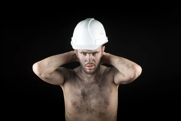 Jonge knappe man in een vuile helm — Stockfoto