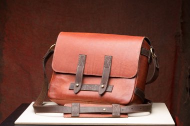 Old vintage leather bag with leather strap clipart