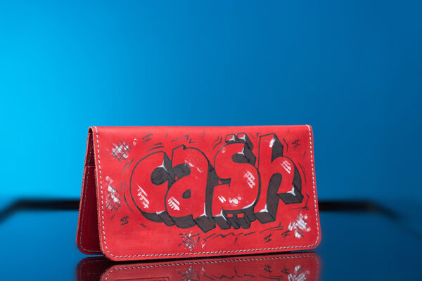 red woman clutch bag. with the words cash