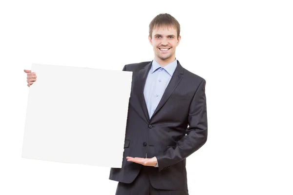 Hombre de negocios sonriente mostrando letrero en blanco —  Fotos de Stock