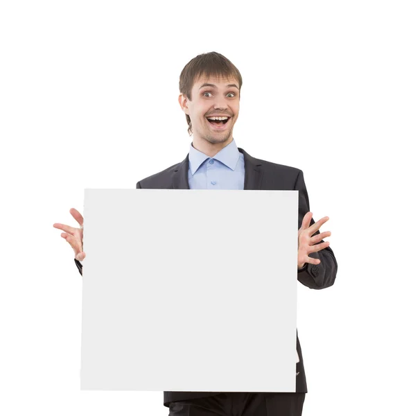 Uomo d'affari sorridente che mostra cartello bianco — Foto Stock