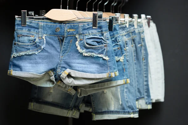 Blue denim shorts on a hanger — Stock Photo, Image