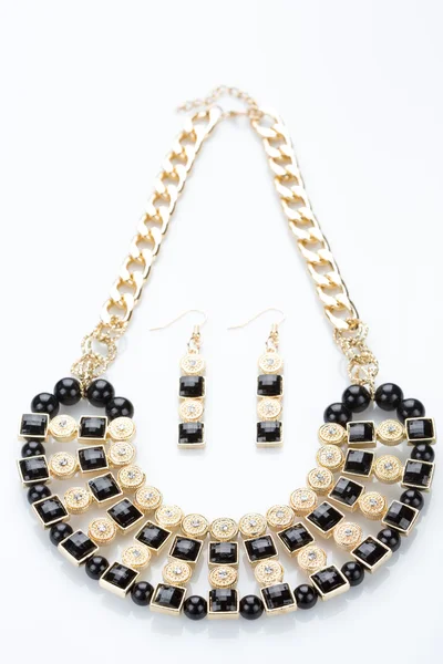 Metal feminine necklace. on white background. earrings — Stock Photo, Image