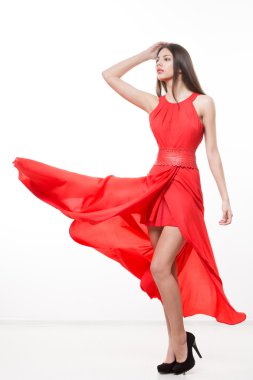 Young beauty woman in fluttering red dress. clipart