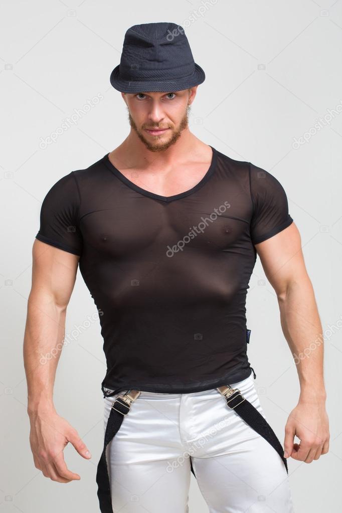 Portrait of muscle man in grey t-shirt and hat