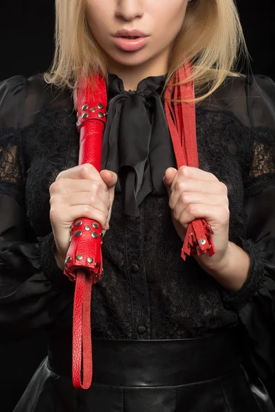 Beautiful woman in biting red whip — Stock Photo, Image