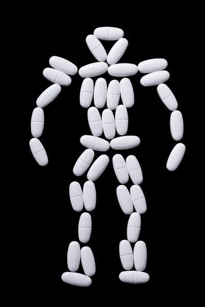 White pills on the black — Stock Photo, Image