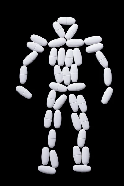 White pills on the black — Stock Photo, Image