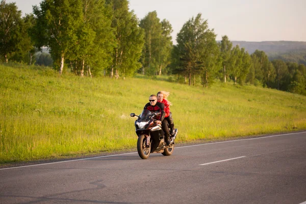 Motorkář muž a žena, sedící na motorce. — Stock fotografie