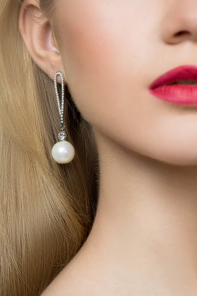 Girl ear in jewelry earrings close up — Stock Photo, Image