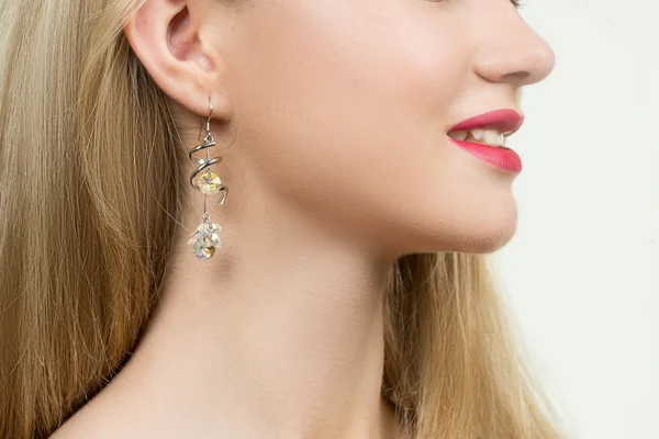 Girl ear in jewelry earrings close up — Stock Photo, Image