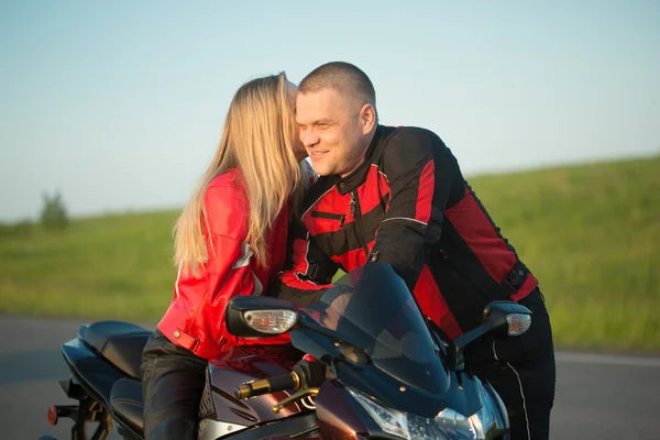 Motociclista uomo e donna seduti su una moto . — Foto Stock