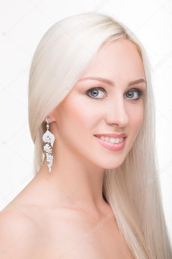 beautiful girl with long white hair and earrings. fashionable photo. portrait