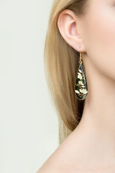 Close up of woman wearing shiny diamond earrings — Stock Photo, Image