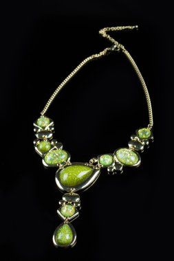 luxury green necklace on black stand