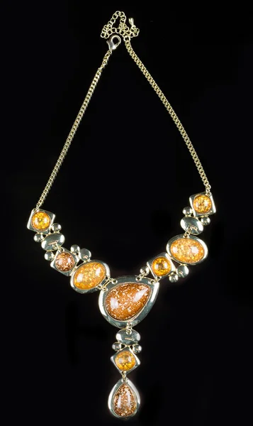 Luxury yellow necklace on black stand — Stok fotoğraf