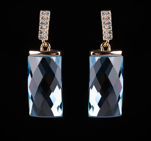 Earring with colorful blue gems on black background — Stock Photo, Image