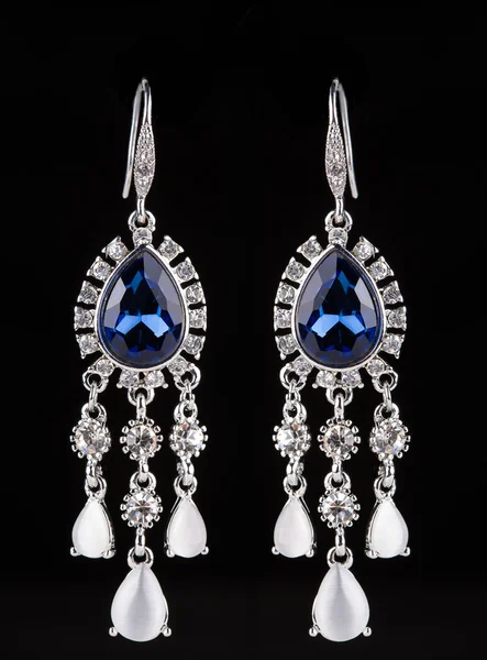 Earring with colorful blue gems on black background — 스톡 사진