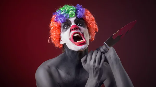 Crazy clown  with a knife — Stock Photo, Image