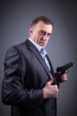 man in a business suit with a gun clipart