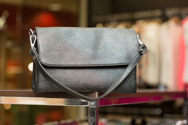 Black bag on a shelf in the store — Stock Photo, Image