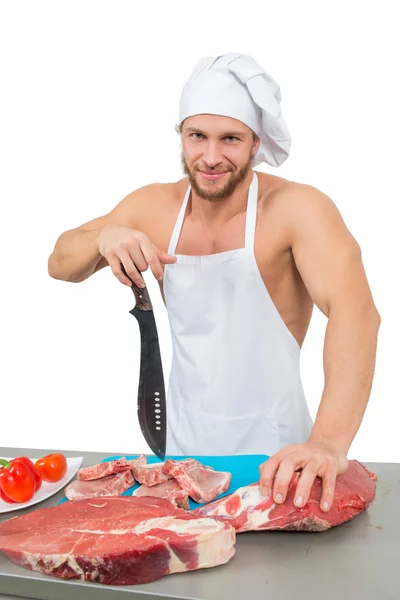 Chef bodybuilder preparing large chunks of raw meat. — Stock Photo, Image