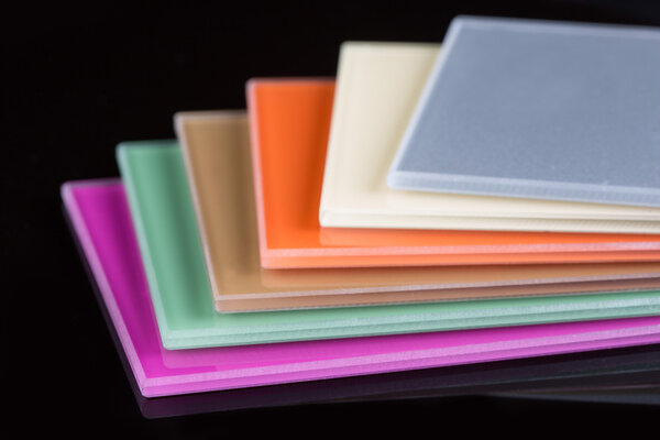 a stack of colored glass on a black background. glass sheets