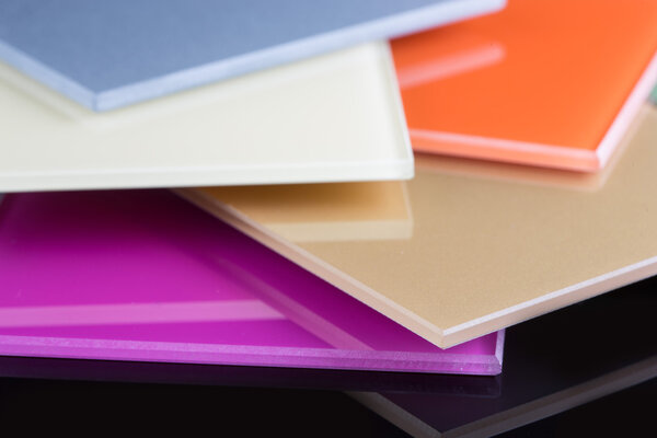 a stack of colored glass on a black background. glass sheets