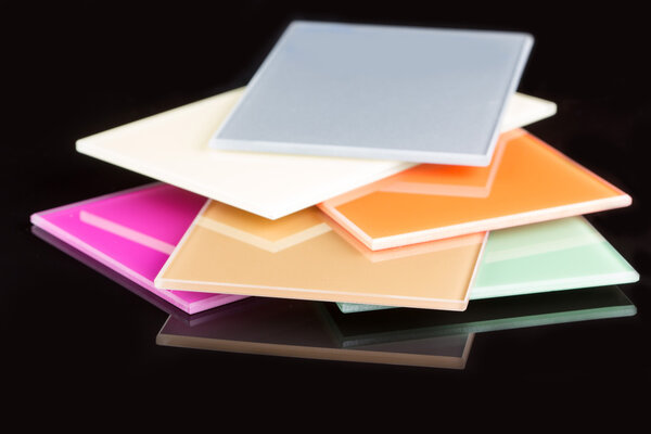 a stack of colored glass on a black background. glass sheets
