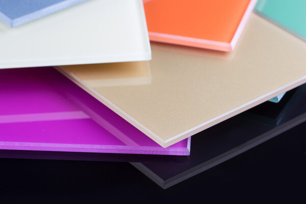 a stack of colored glass on a black background. glass sheets