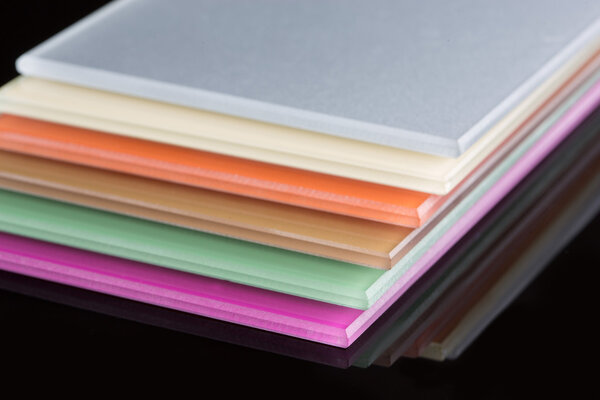 a stack of colored glass on a black background. glass sheets