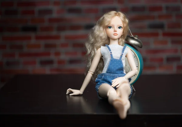 Doll on a background of a brick wall. — Stock Photo, Image