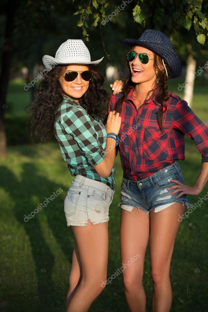 Sexy girl in cowboy hats and plaid shirts. sunglasses — Stock Photo ...