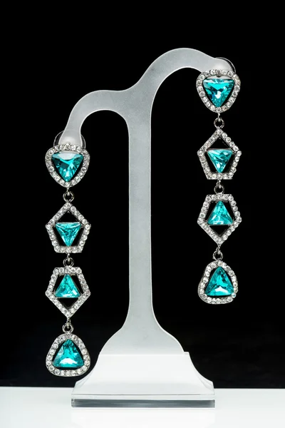 Earrings with blue stones on the black — Stock Photo, Image