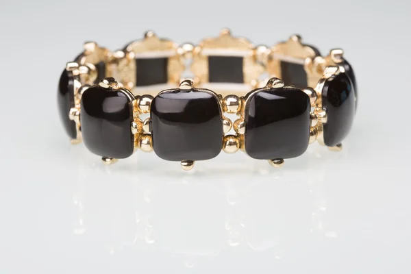 Bracelet with black  stones over white — Stock Photo, Image