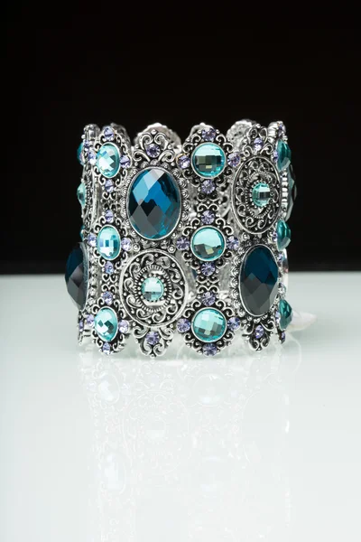 Bracelet with blue stones over black — Stock Photo, Image