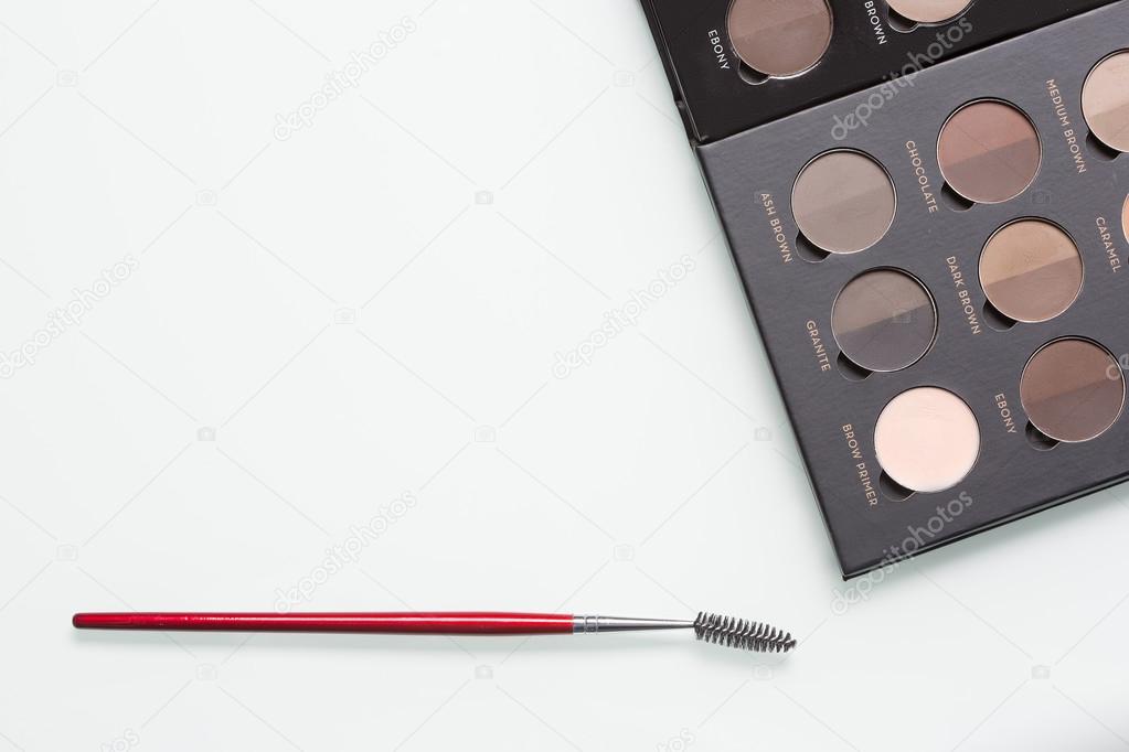 Eye shadows of different colors and make-up brushes