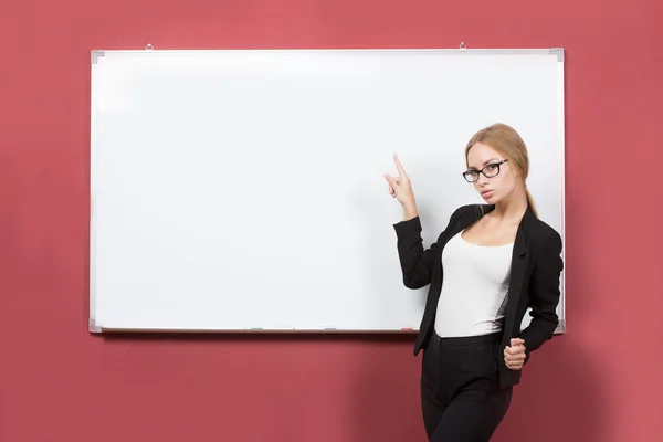 Business girl shows forefinger hand on the blank banner — Stock Photo, Image