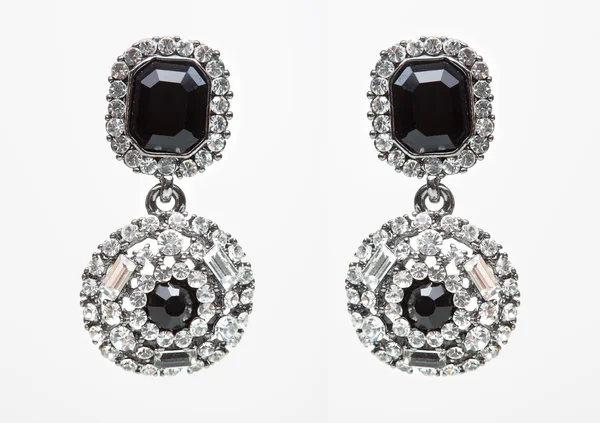 Earrings with black stones on the white — Stock Photo, Image