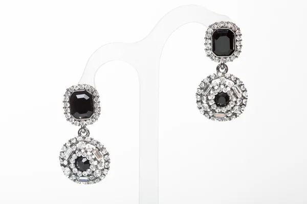 Earrings with black stones on the white — Stock Photo, Image