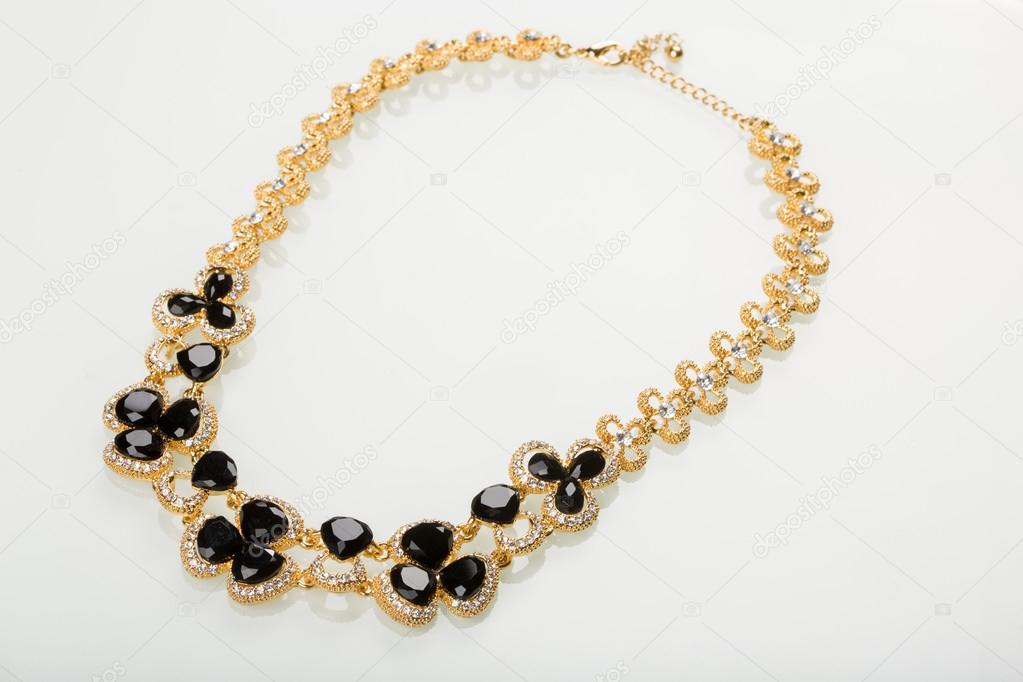 Necklace with black pearls on a white 