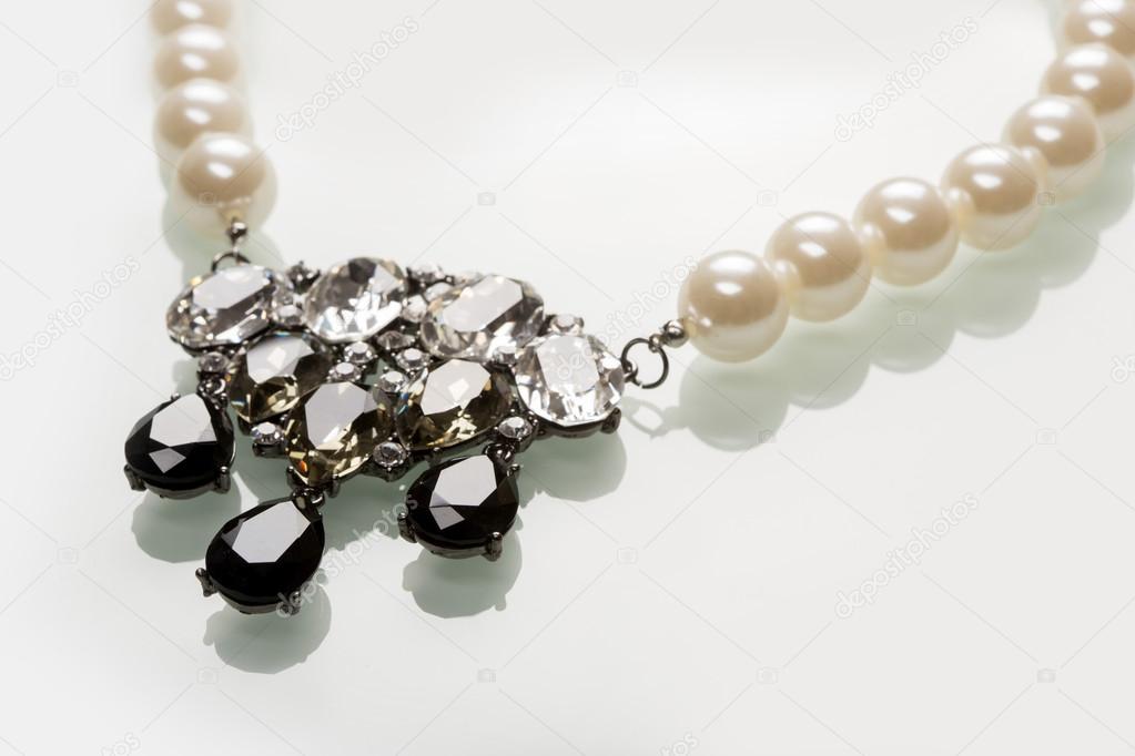 pearl necklace with black stones on a white 