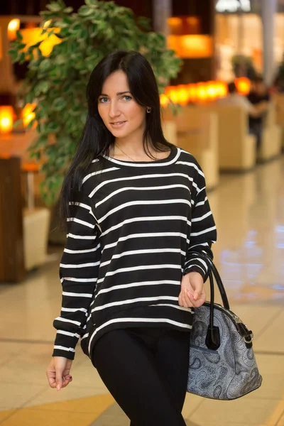 Girl in a striped blouse with a bag — Stock Photo, Image