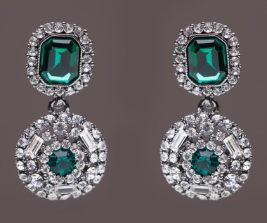earrings with green stones on the gray clipart