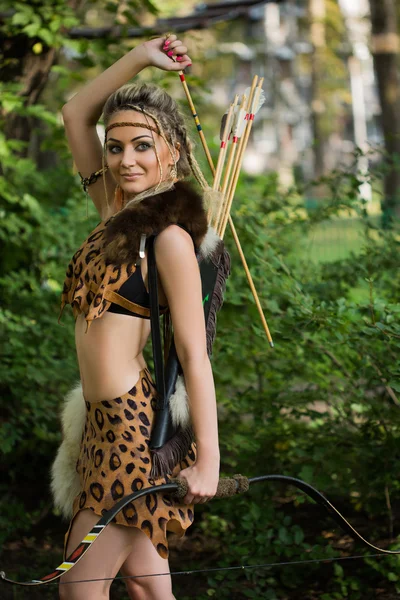 Amazona mujer posando con arco en bosque verde —  Fotos de Stock
